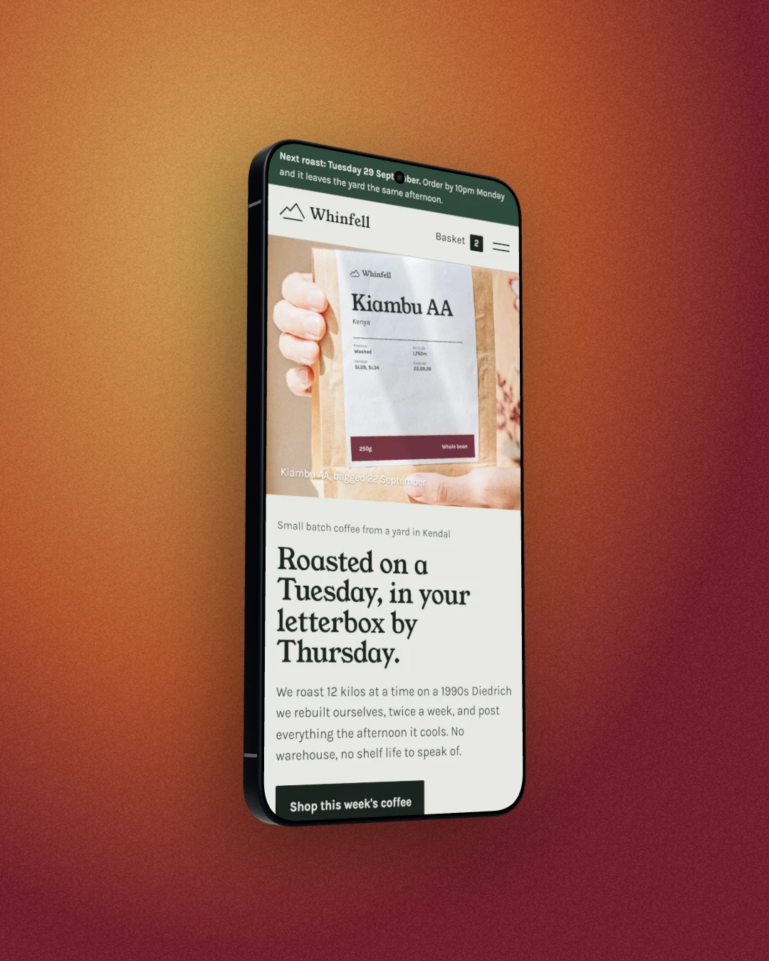 The Whinfell Roasters site on a 3D Galaxy S26 Ultra turned to show its flat side, on a rust orange studio backdrop